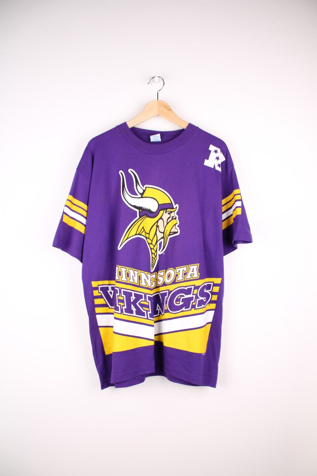 Minnesota Vikings NHL T-Shirt in purple with yellow stripe detailing, a viking graphic and team name spellout on the front, and large V design on the back..