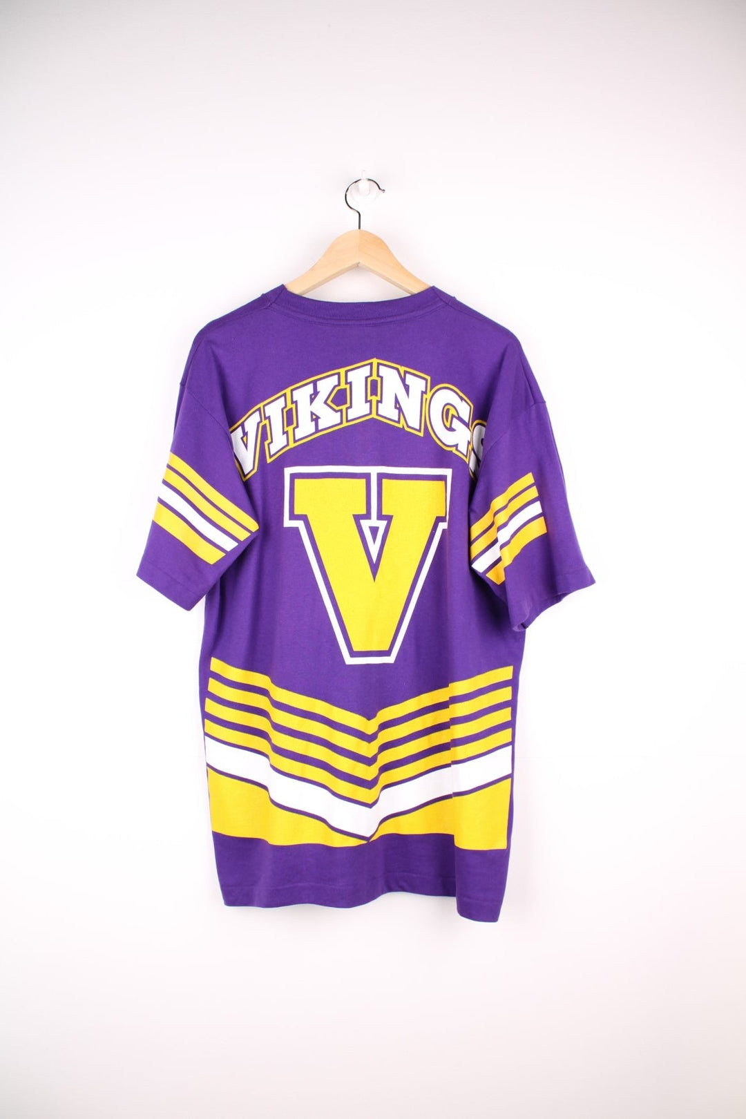 Minnesota Vikings NHL T-Shirt in purple with yellow stripe detailing, a viking graphic and team name spellout on the front, and large V design on the back..