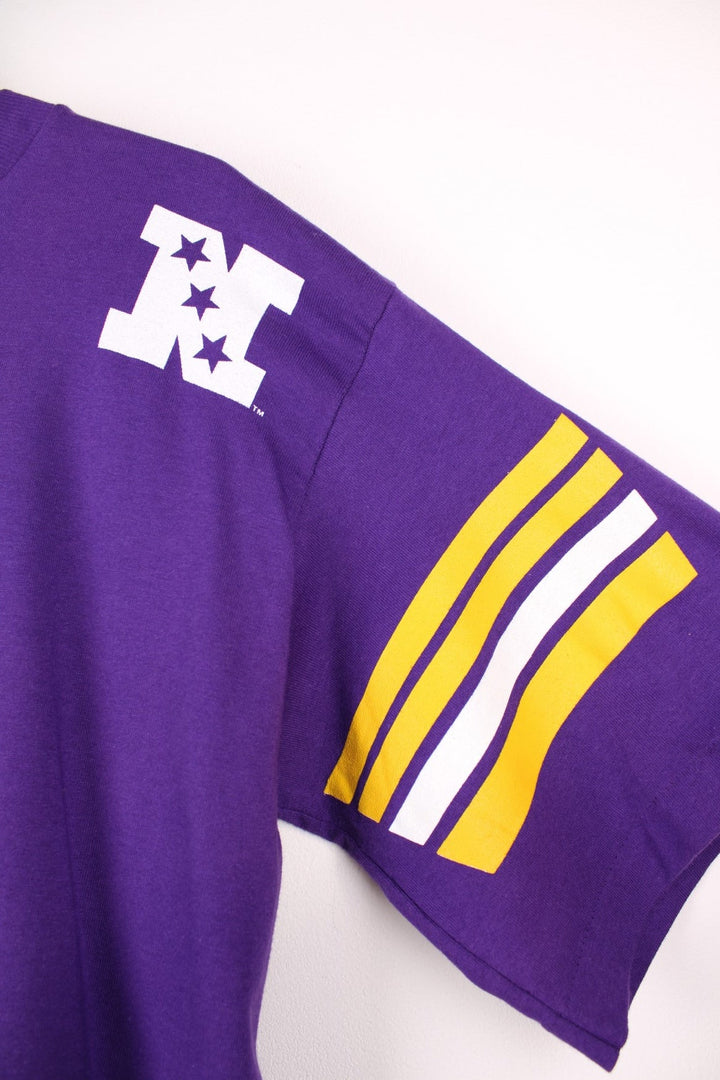 Minnesota Vikings NHL T-Shirt in purple with yellow stripe detailing, a viking graphic and team name spellout on the front, and large V design on the back..