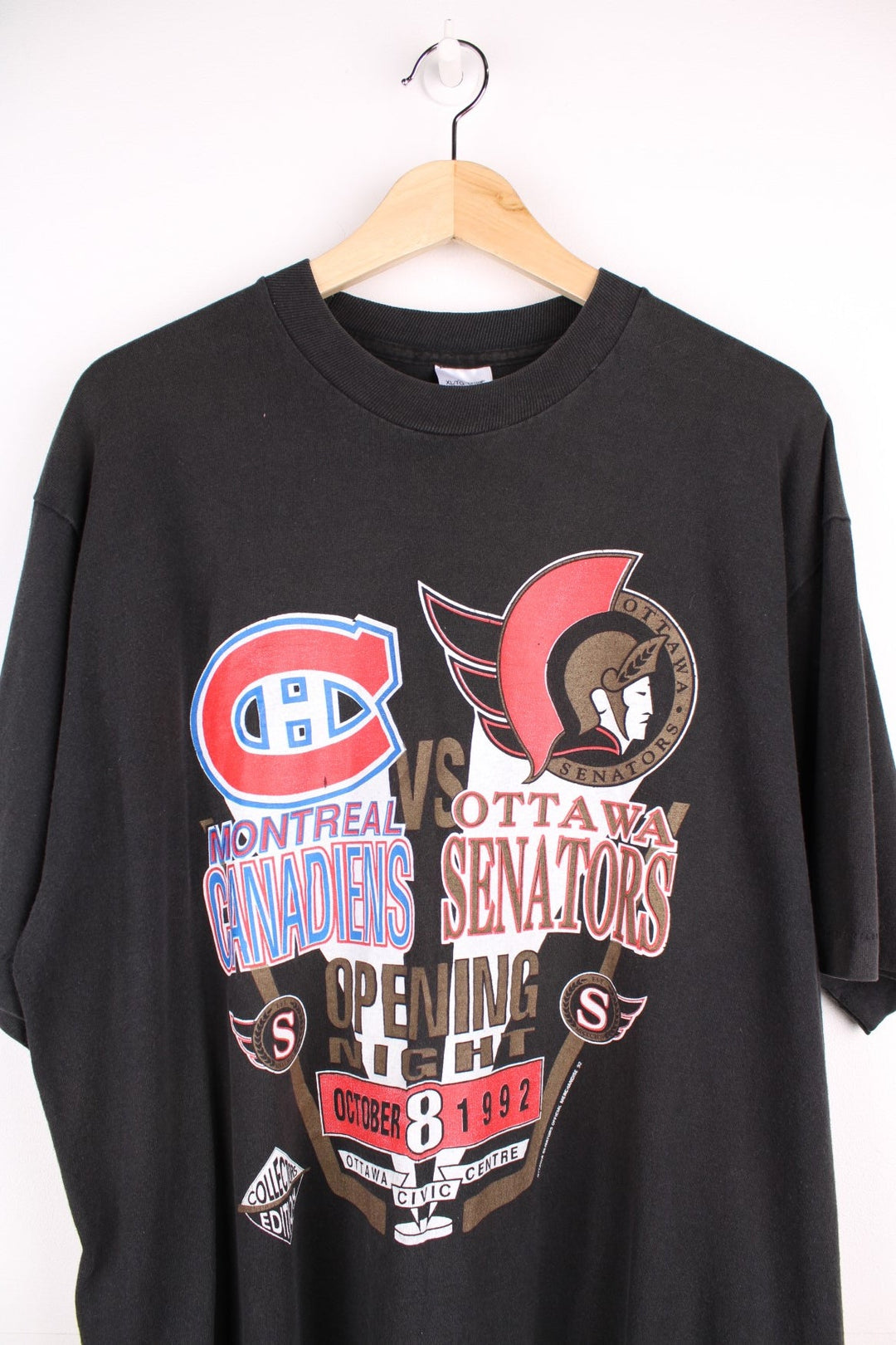 1992 Montreal Canadiens vs Ottawa SenatorsNHL T-Shirt in black with team logo crests on the front, and coloseum graphic on the back with spellout reading 'Dawn of a New Empire' Signed on the back.