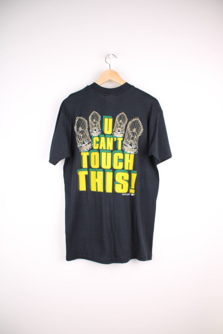 Oakland Athletics MLB t-shirt in black with baseball bat graohic and spellout reading 'Hammer Time' and 'U Can't Touch This' in green and yellow on the front and back.