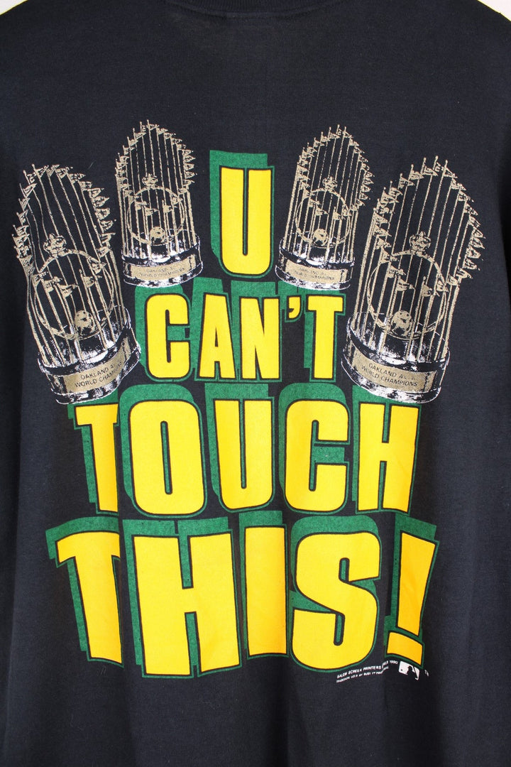 Oakland Athletics MLB t-shirt in black with baseball bat graohic and spellout reading 'Hammer Time' and 'U Can't Touch This' in green and yellow on the front and back.