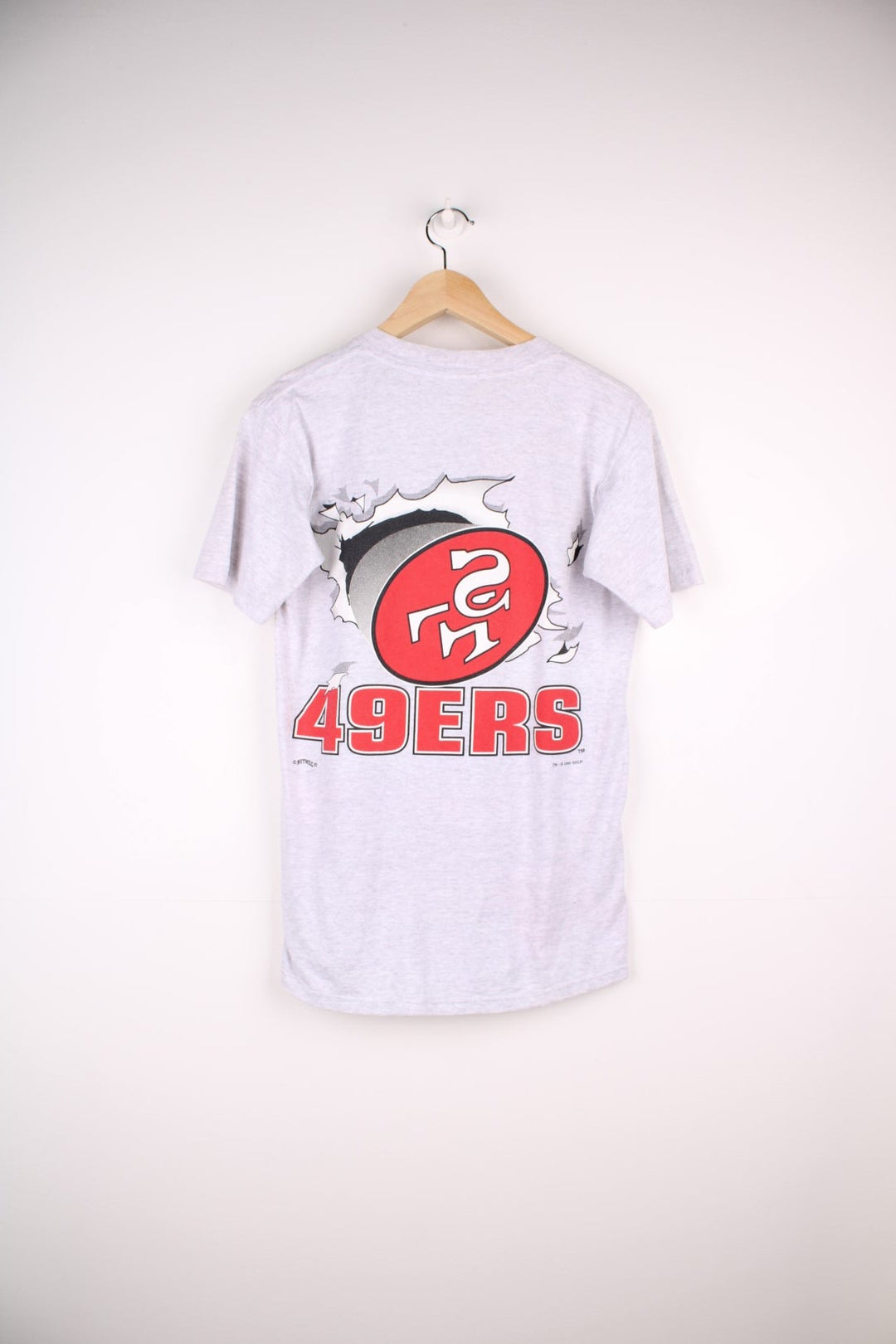 San Francisco 49ers NFL t-shirt in grey with front and back graphic of team logo bursting through the t-shirt.