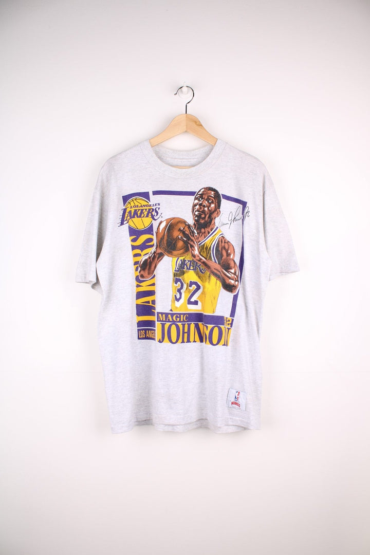 Los Angeles Lakers NBA Magic Johnson t-shirt in grey with yellow and purple accents, multiple team/NFL logos, illustrations of Johnson and his stats and a bio written on the back.