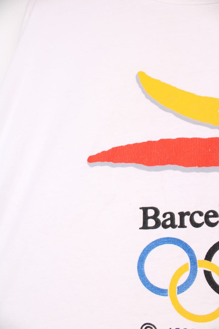 Vintage 1992 Barcelona Olympics tee in white with red, yellow and blue abstract designs and Seiko sponsorship spellout.