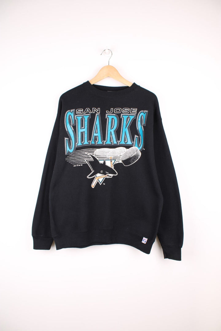 1992 San Jose Sharks Sweatshirt in a black, blue and white colourway with the spell out and team logo printed across the front. 