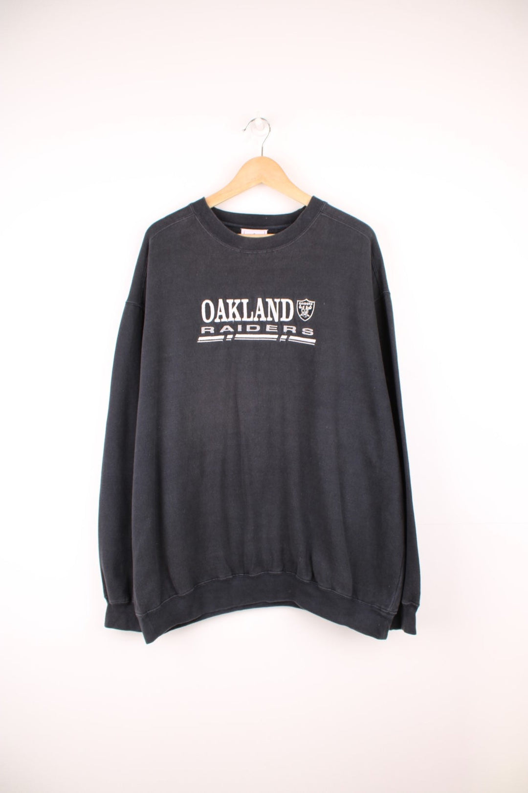 NFL Oakland Raiders Sweatshirt in a black colourway with the team logo and spell out embroidered across the front. 