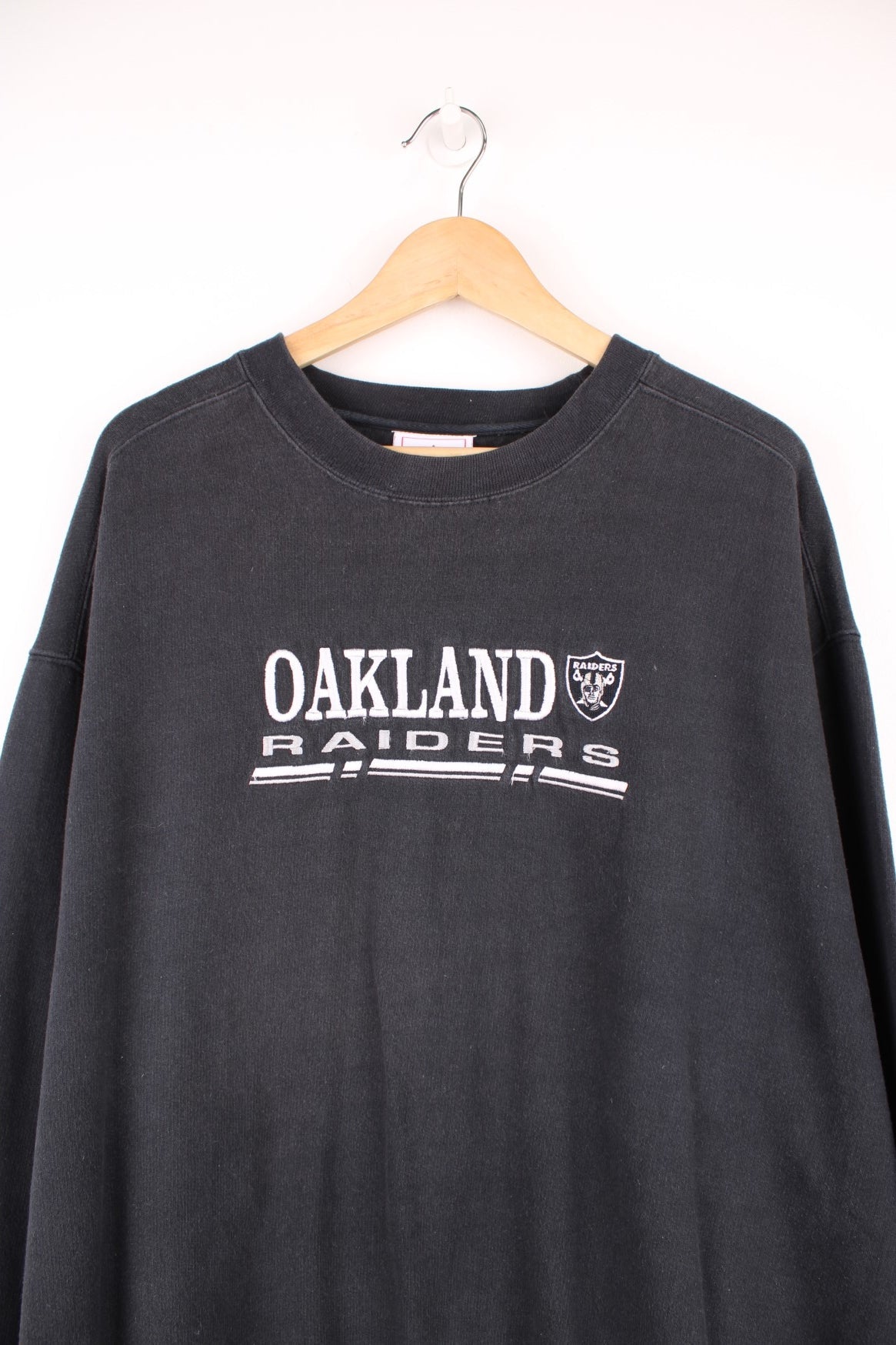 NFL Oakland Raiders Sweatshirt in a black colourway with the team logo and spell out embroidered across the front. 