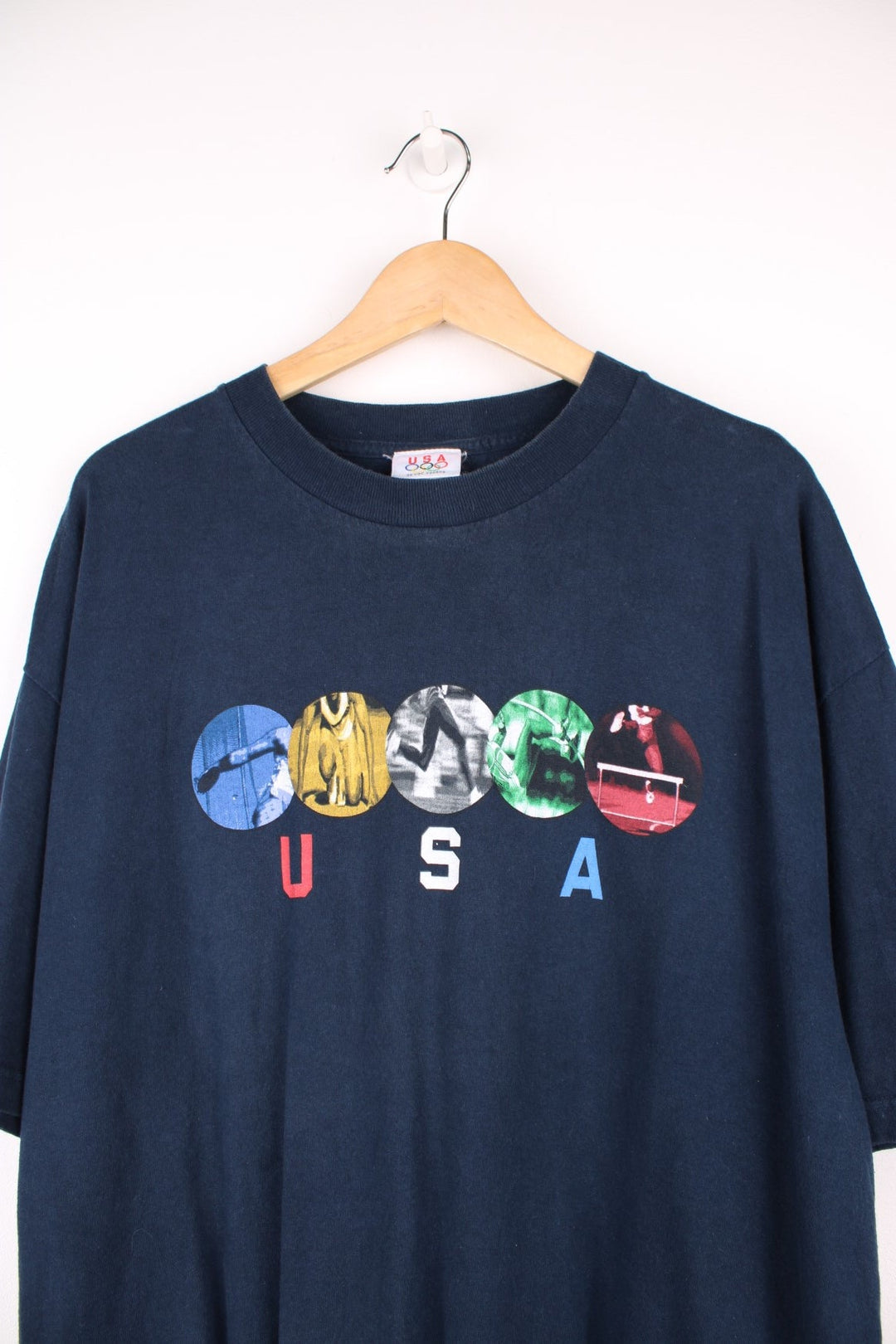 USA Olympics Track & Field T-Shirt in a navy blue colourway with the spell out and sports graphic printed on the front. 