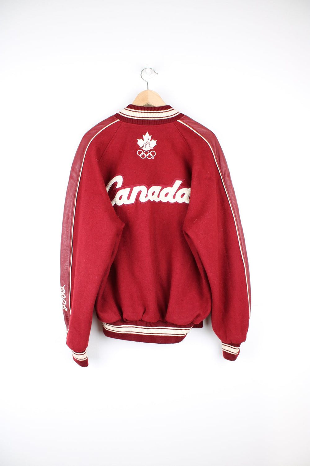 Vintage 2002 Winter Olympics team Canada varsity jacket, by Roots. Features embroidered badges and spell-out details