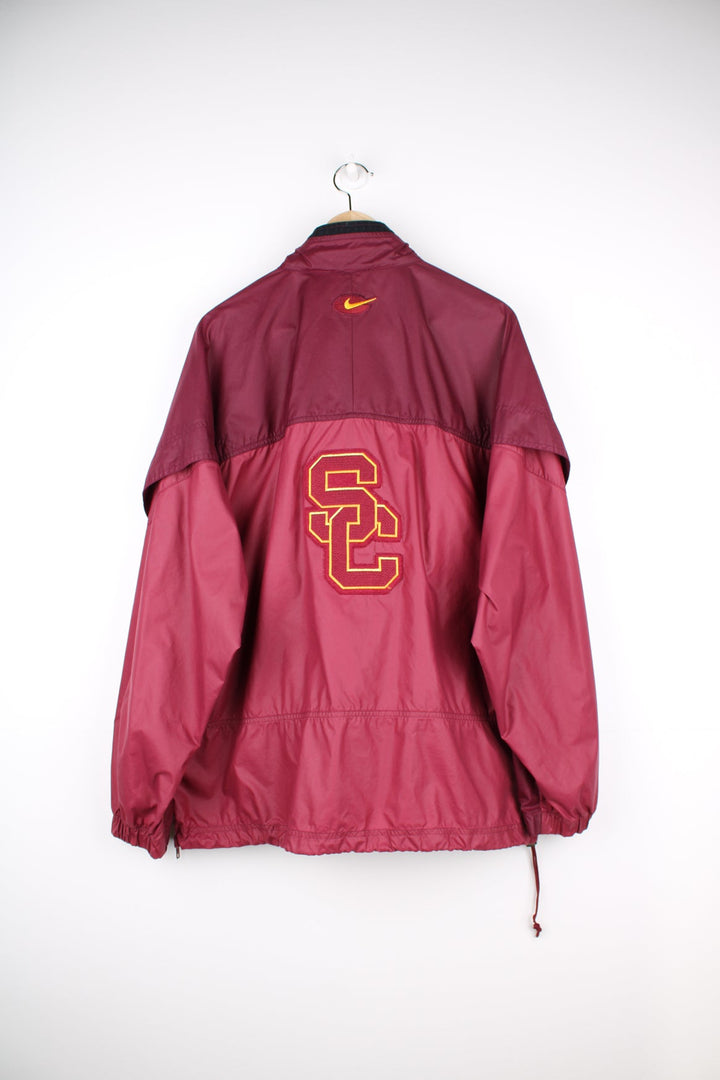 vintage 90's Nike USC Trojans maroon 1/4 nylon track jacket with embroidered patches on the front and back