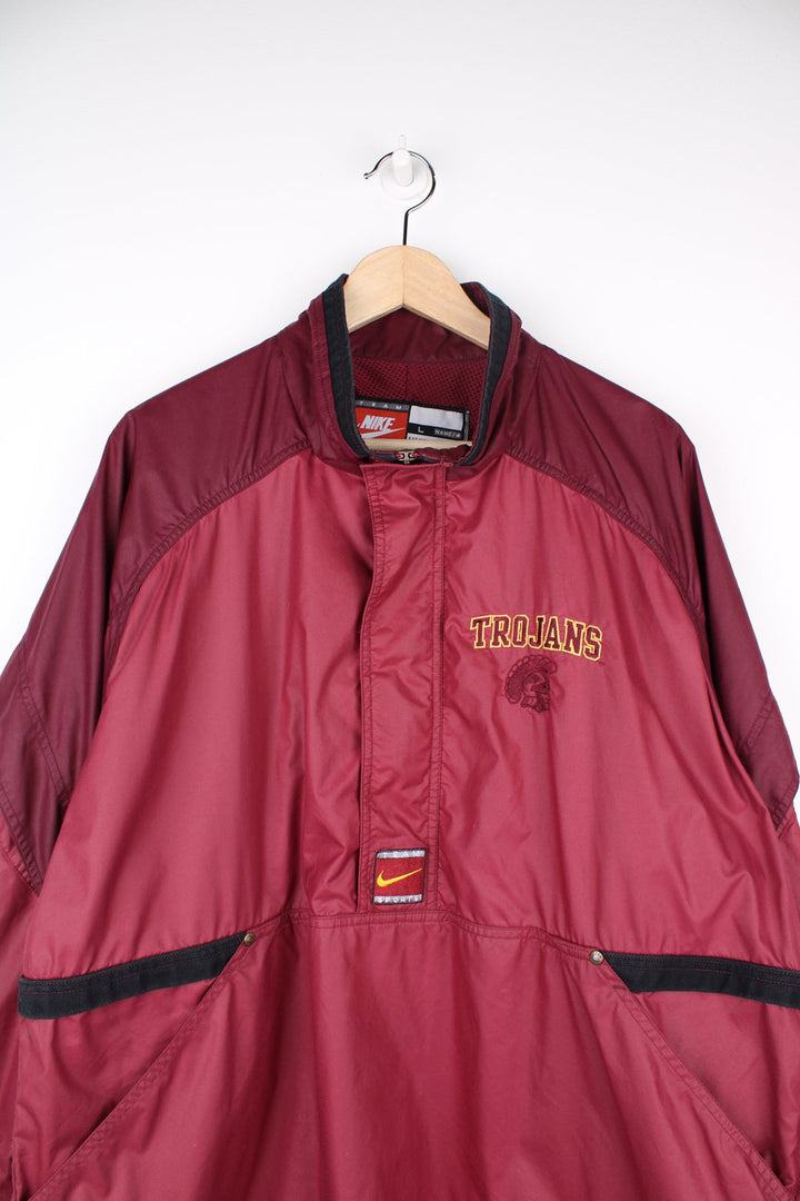 vintage 90's Nike USC Trojans maroon 1/4 nylon track jacket with embroidered patches on the front and back