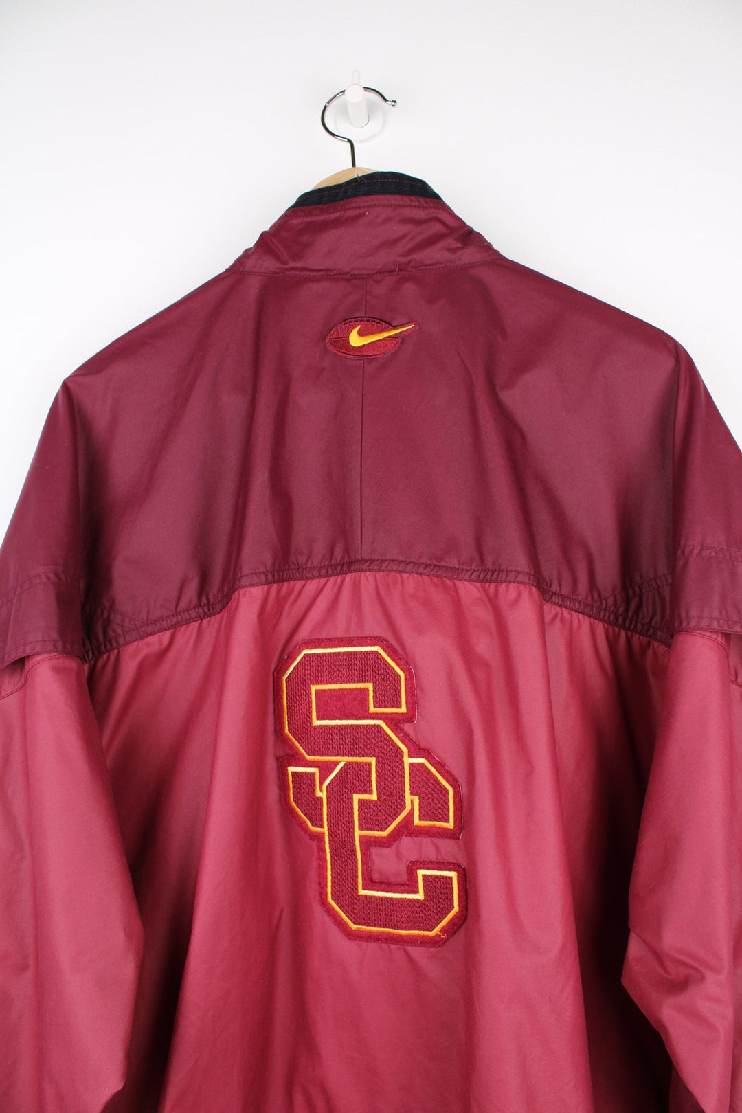 vintage 90's Nike USC Trojans maroon 1/4 nylon track jacket with embroidered patches on the front and back