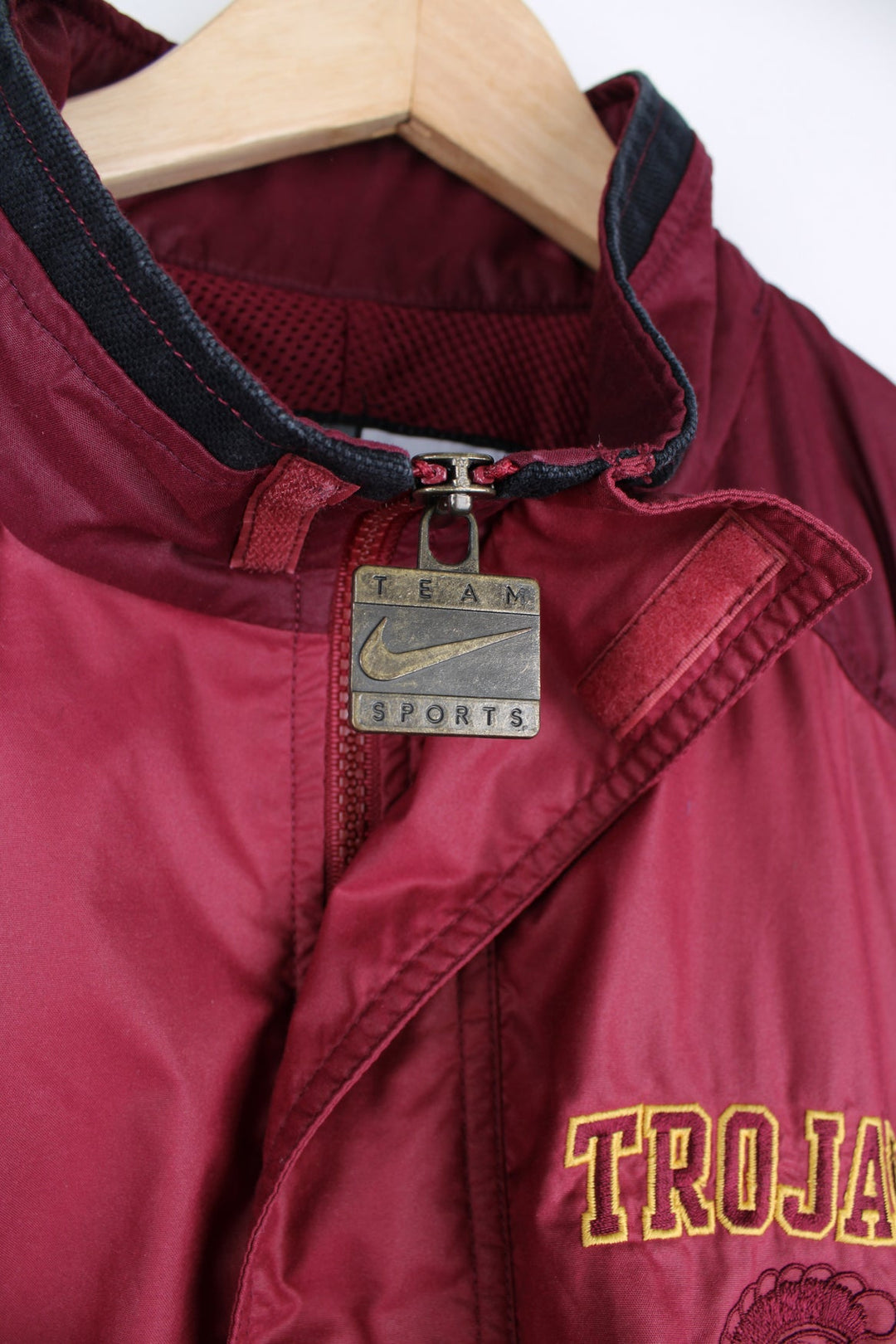 vintage 90's Nike USC Trojans maroon 1/4 nylon track jacket with embroidered patches on the front and back