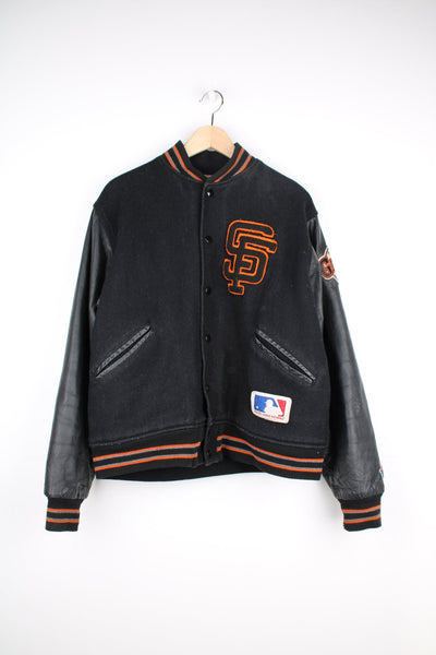 Vintage 90s San Francisco Giants official MLB black wool varsity jacket, features snap buttons, quilted lining and embroidered badges/logos