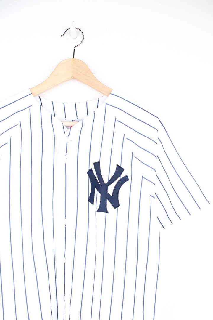 Vintage New York Yankees #2 Derek Jeter MLB jersey by Majestic. Features embroidered lettering and pinstripe print