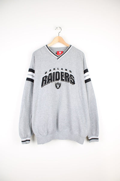 Vintage 90s Oakland Raiders sweatshirt with embroidered logo across the chest.