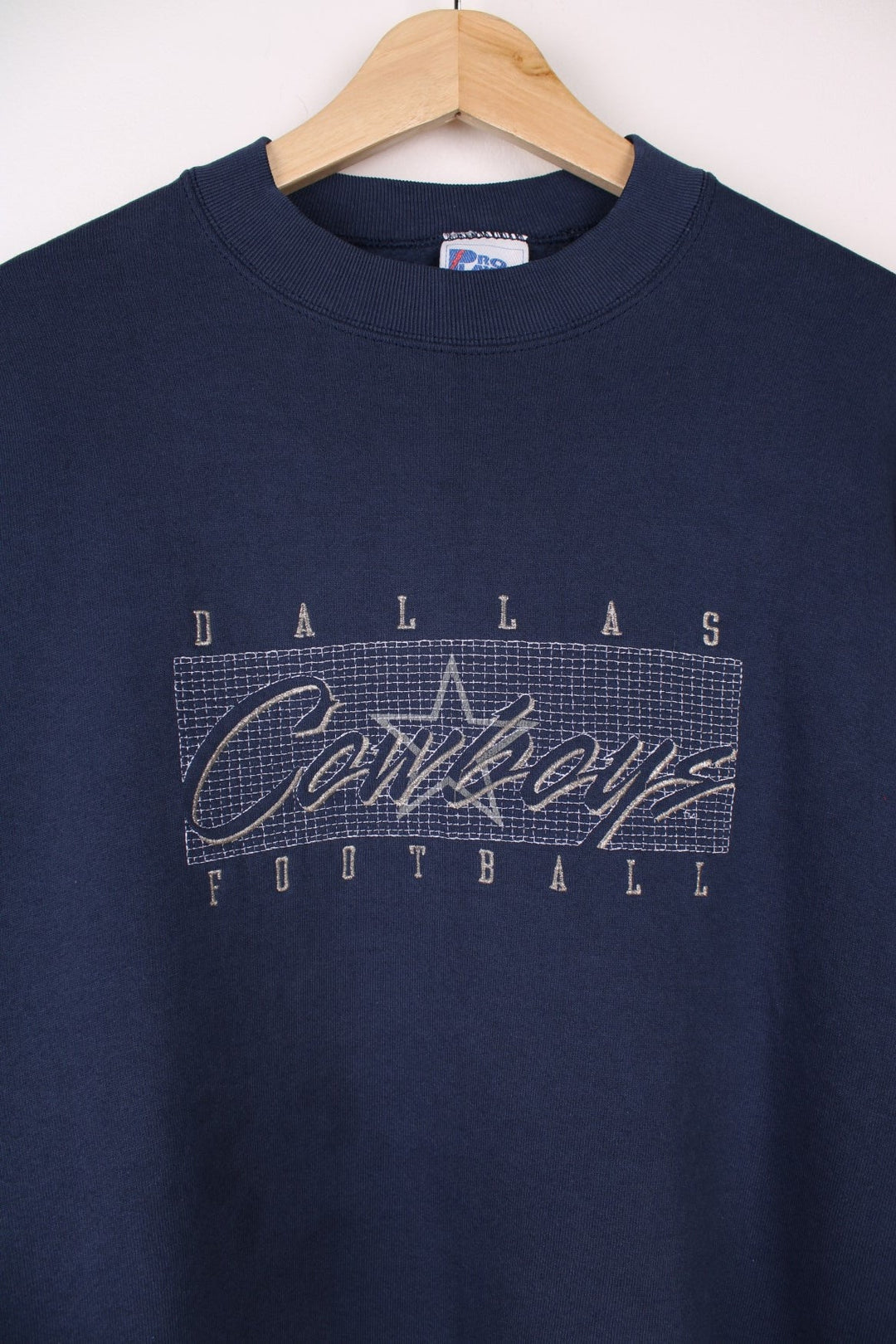 Dallas Cowboys  Sweatshirt in a navy  colourway with the team spell out logo embroidered across the front.