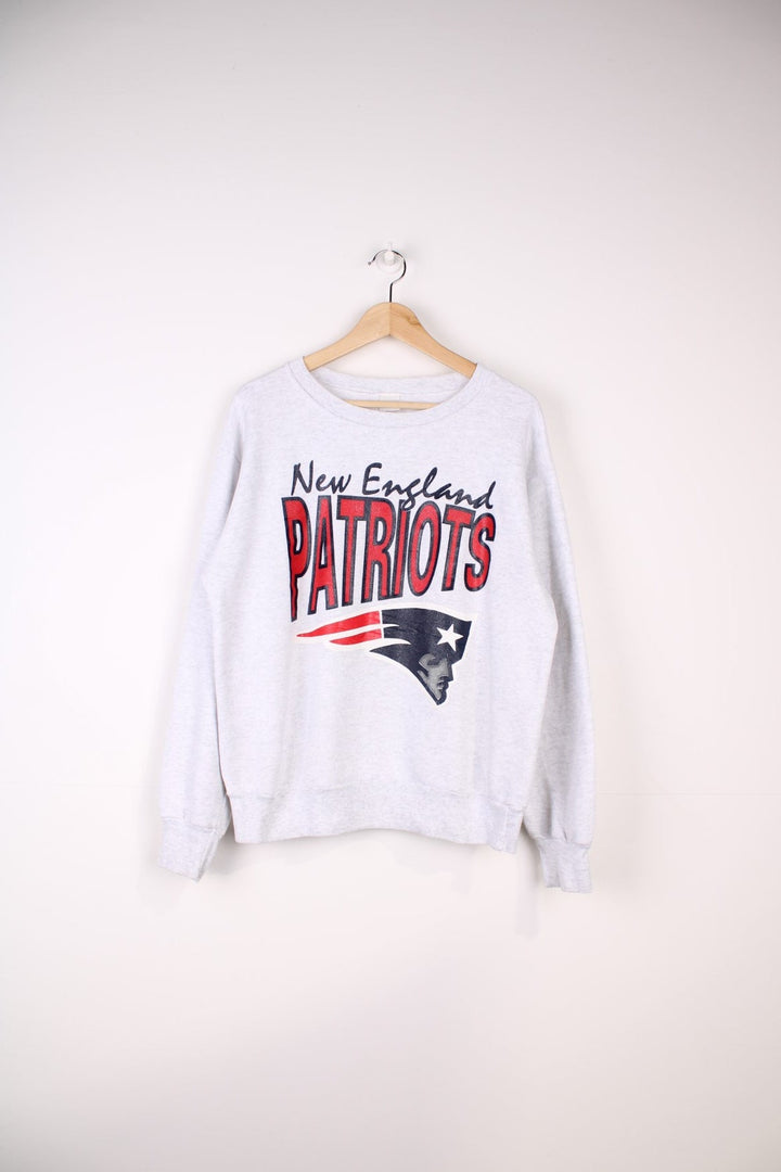 Vintage New England Patriots NFL Sweatshirt in a grey colourway with the team logo and spell out printed across the front.