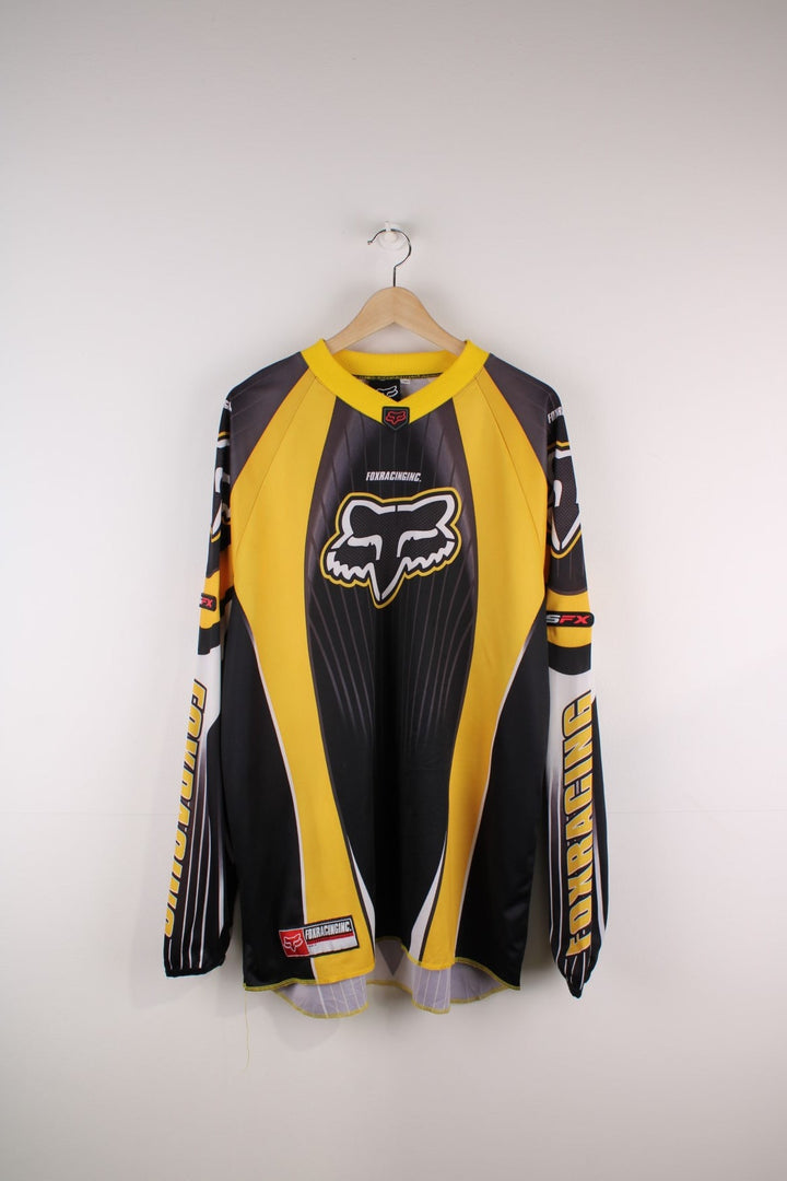 Vintage 90's Fox Racing Motorcross Jersey in a black and yellow colourway, has the spell out and logo printed on the front and going down the sleeves.