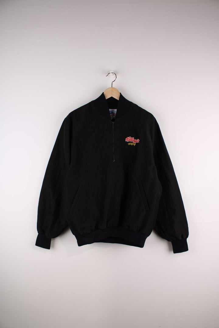 Vintage Kellogs Racing Starter Pullover Windbreaker in a black colourway, half zips up, has side pockets, and the spell out logo emboridered on the chest.