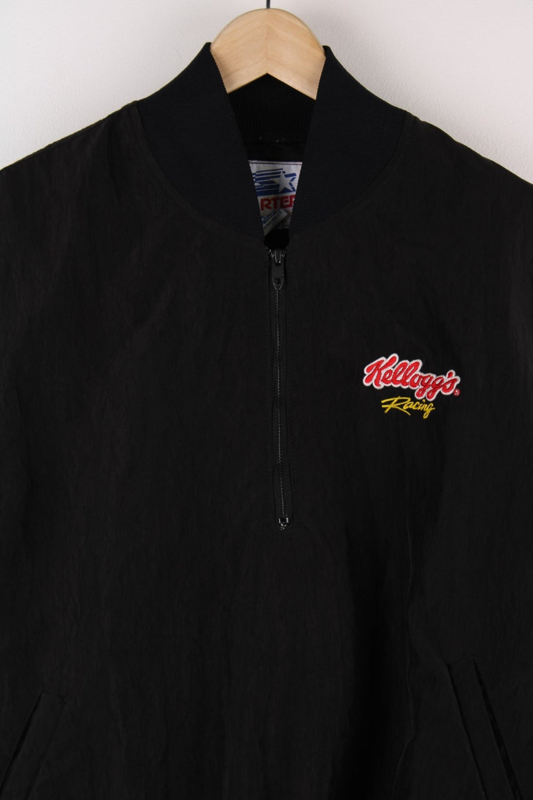 Vintage Kellogs Racing  Pullover Windbreaker in a  colourway, half zips up, has side pockets, and the spell out logo emboridered on the chest.