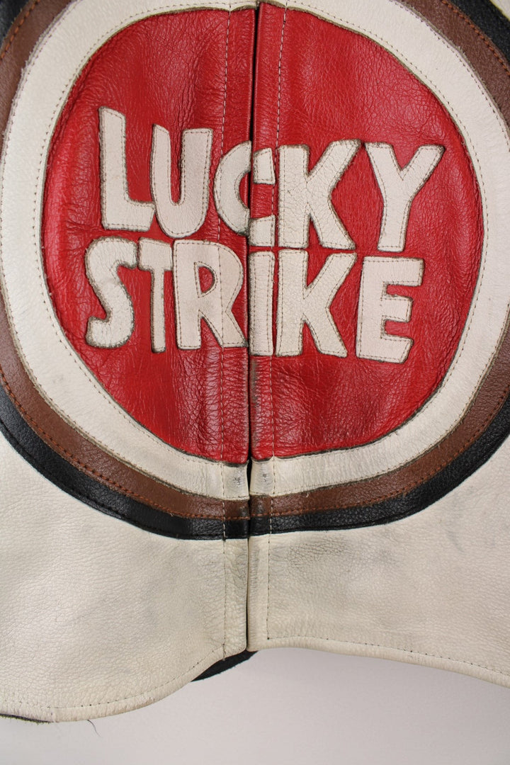 Vintage Lucky Strike  Racing Jacket in a  and red colourway, zips up with side pockets, and has logo embroidered all over the jacket and the back is signed.