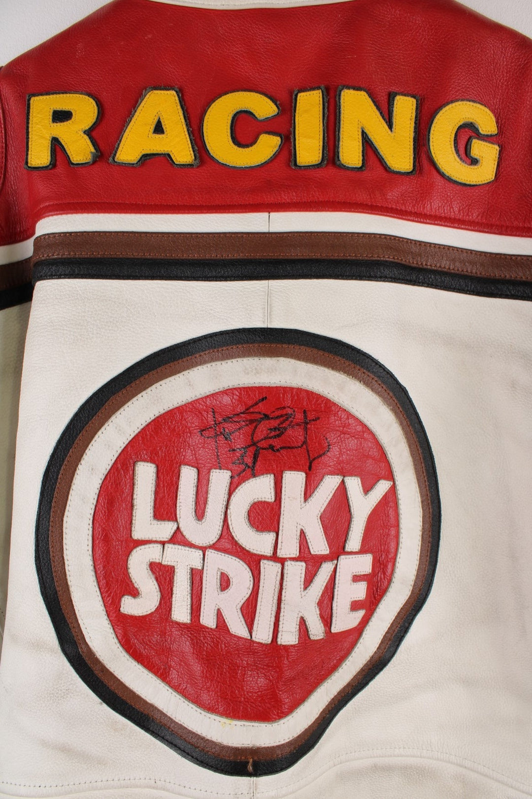 Vintage Lucky Strike  Racing Jacket in a  and red colourway, zips up with side pockets, and has logo embroidered all over the jacket and the back is signed.