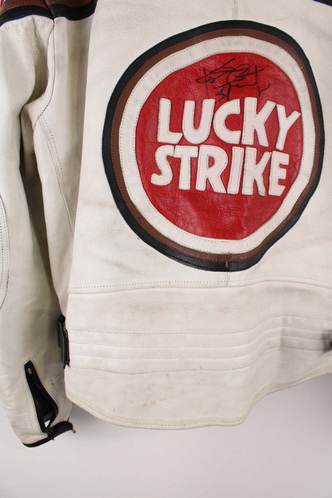 Vintage Lucky Strike  Racing Jacket in a  and red colourway, zips up with side pockets, and has logo embroidered all over the jacket and the back is signed.