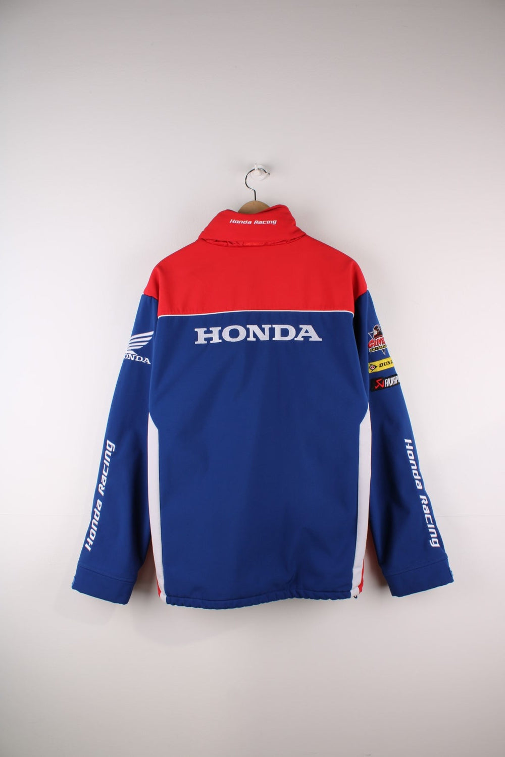  Honda Softshell Racing Jacket in a  and red colourway, zips up and has side pockets, hidden hood, and the logos embroidered all over the jacket.