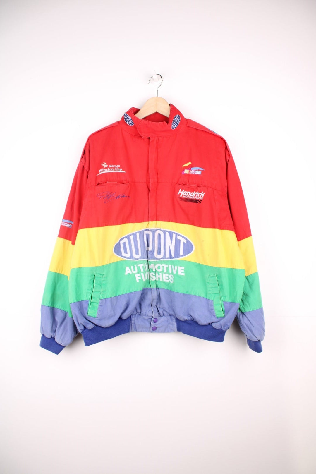 Vintage Jeff Gordon Du Pont, NASCAR bomber jacket in red, yellow, green and blue. Features embroidered logo and badge.