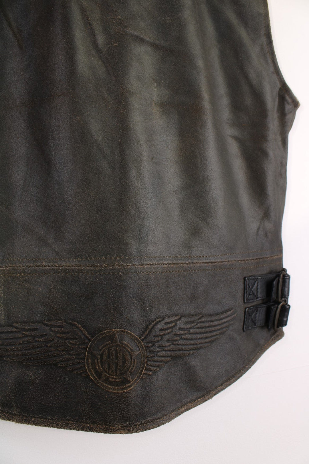 Vintage  Leather Biker Vest in a  colourway, zips up and has a v neck collar, side pockets, and the logo embroidered on the back.