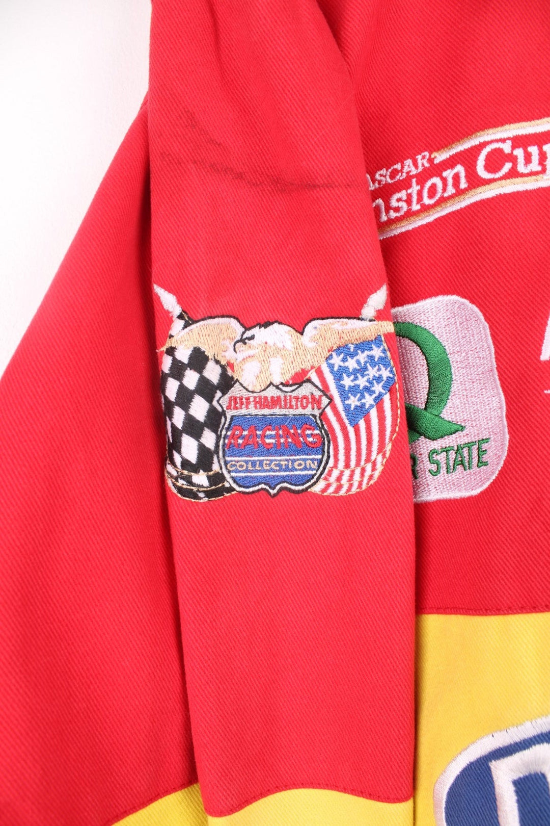 Vintage Jeff Gordon Du Pont, NASCAR bomber jacket in red, yellow, green and blue. Features embroidered badges.