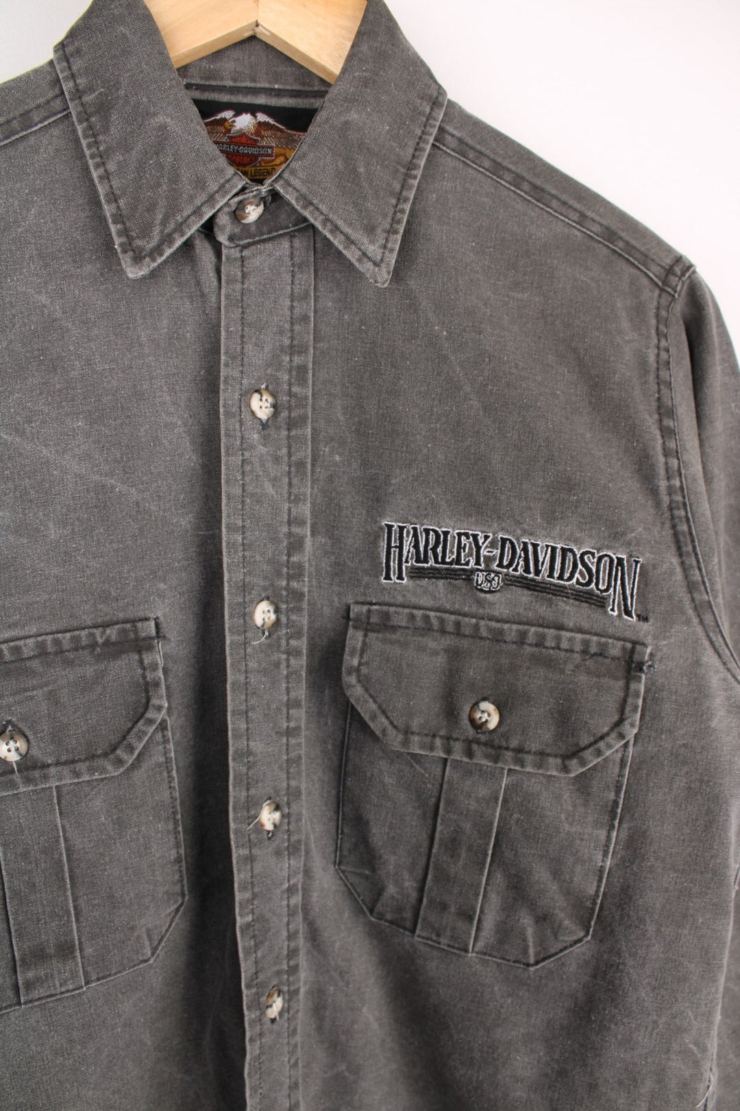  Shirt in a denim  colourway, buttons up, has double chest pockets, and the spell out logo embroidered on the front.