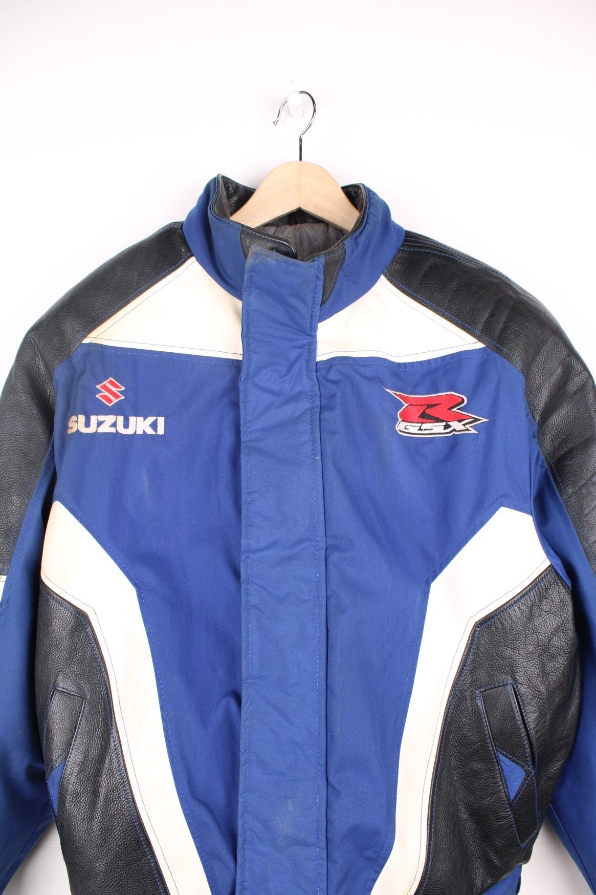 Vintage Suzuki racing jacket in blue, black and white. Features embroidered logo. 