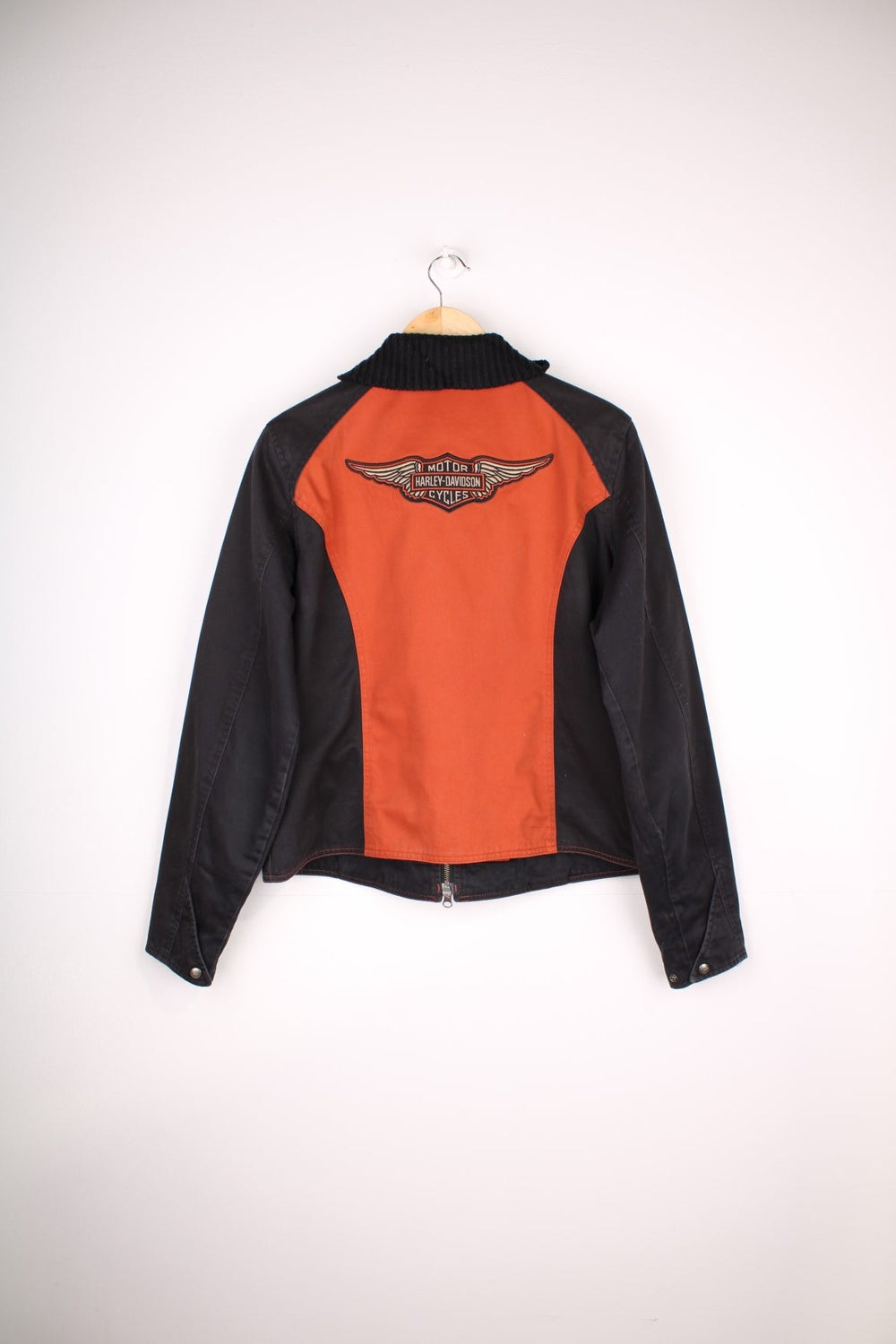  Jacket in a  and orange colourway, zips up and has a big collar, side pockets, and the spell out logo embroidered across the front.