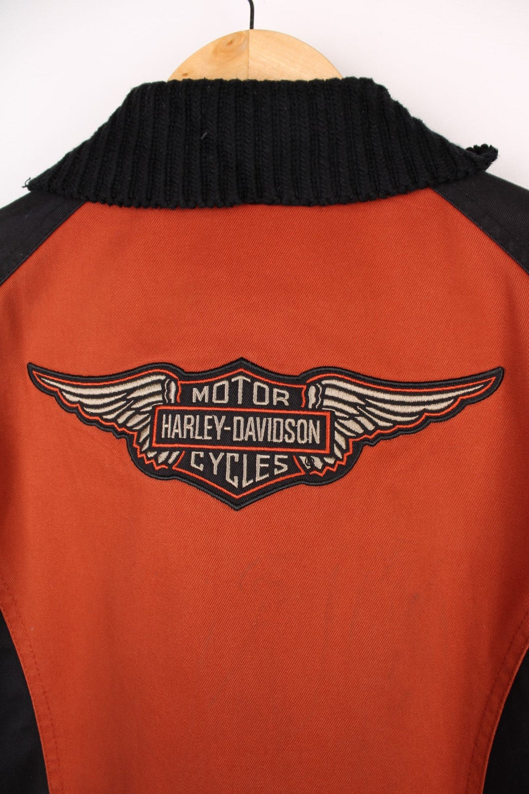  Jacket in a  and orange colourway, zips up and has a big collar, side pockets, and the spell out logo embroidered across the front.