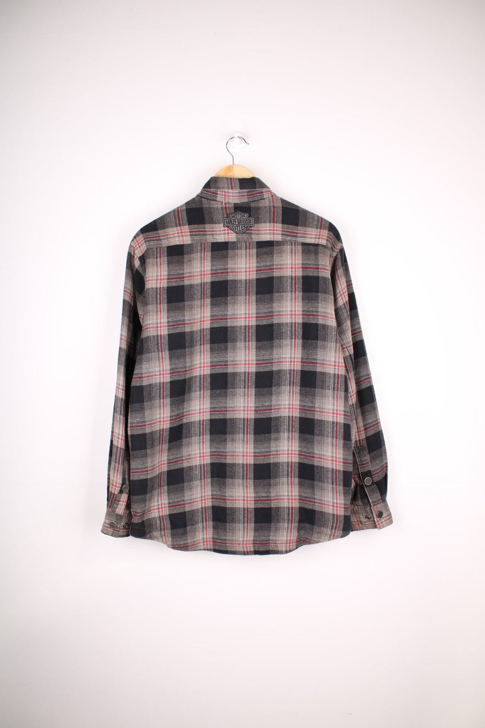  Flannel Style Shacket in a , black and red plaid colourway, buttons up, has multiple pockets, quilted lining and the logo embroidered on the front and back.