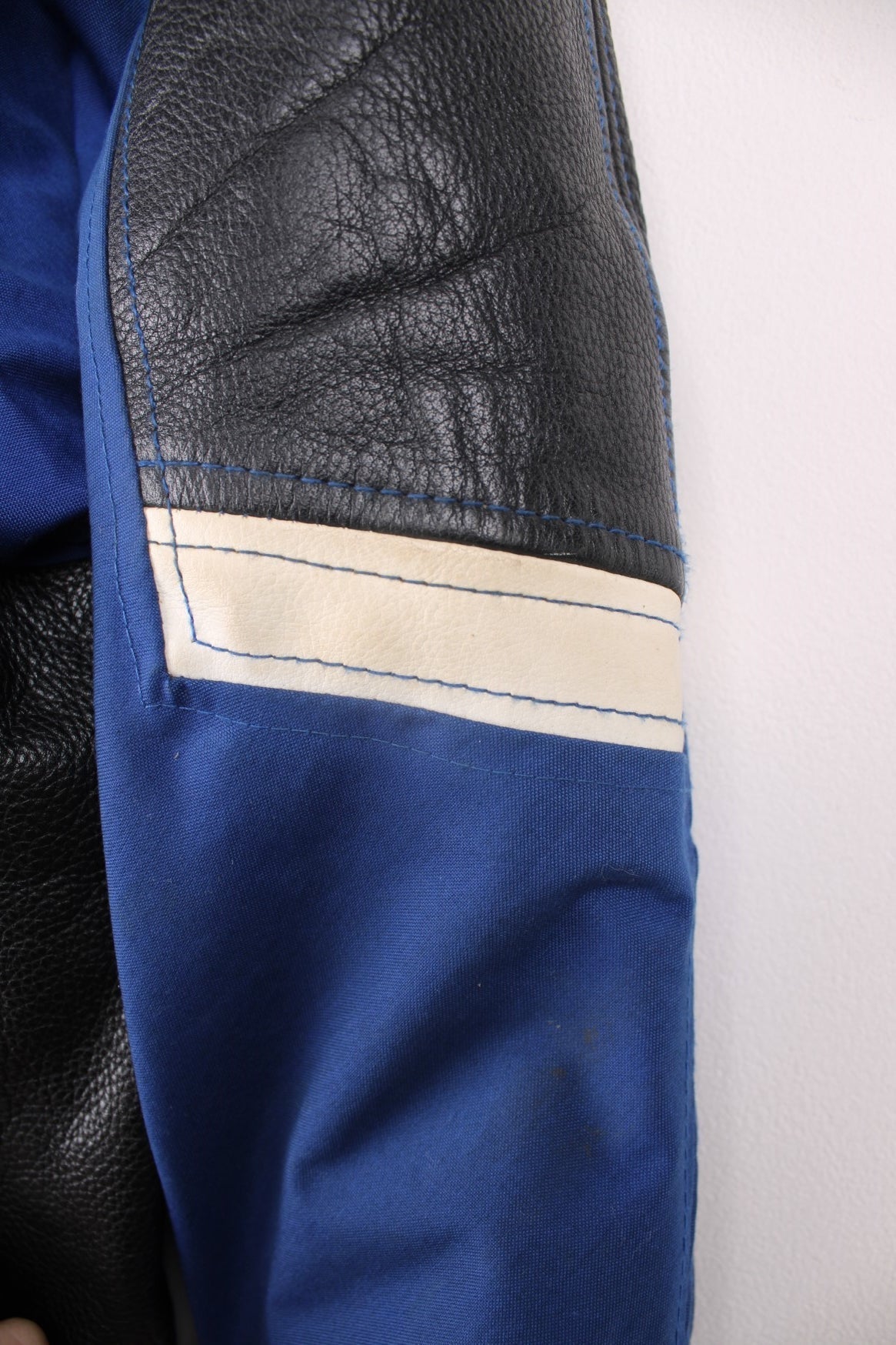 Vintage Suzuki racing jacket in blue, black and white. Features embroidered logo. 