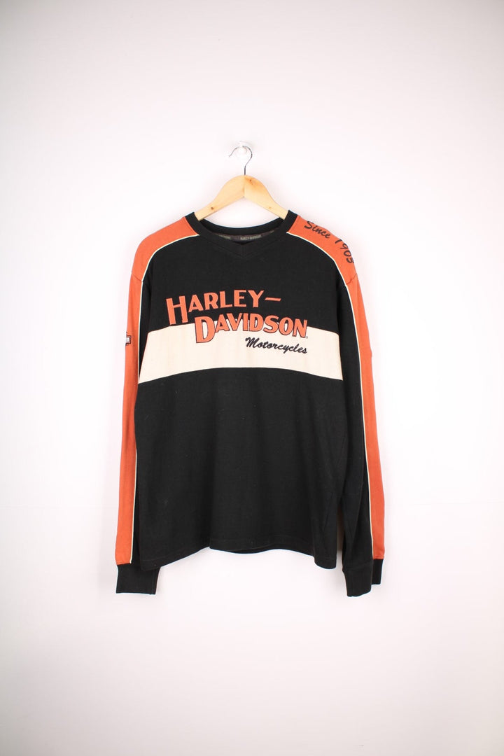 Harley-Davidson Sweatshirt in a black, orange and white colourway, has a v neck collar, quilted lining and the logo embroidered on the front, back and down the sleeves.