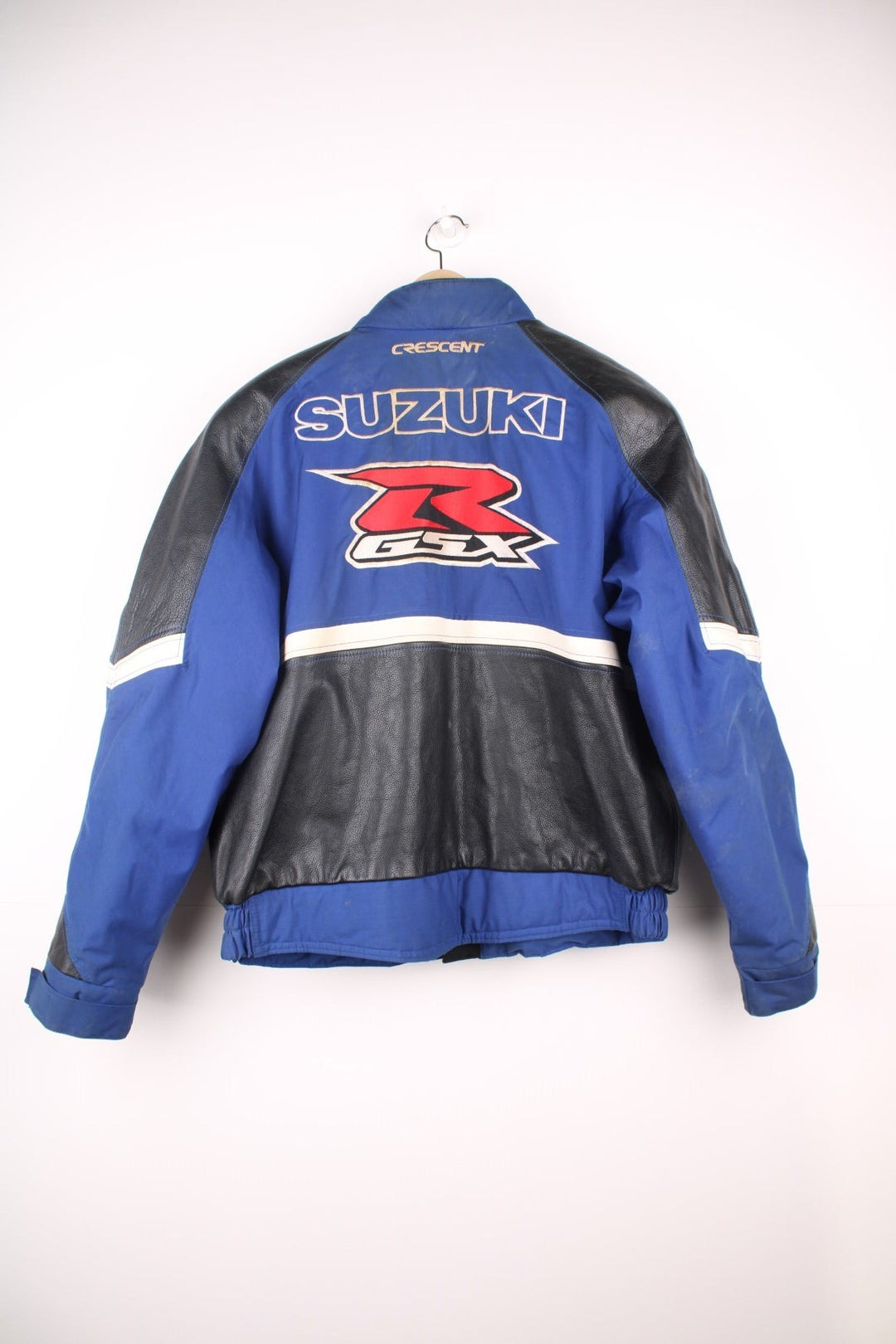 Vintage Suzuki racing jacket in blue, black and white. Features embroidered logo. 