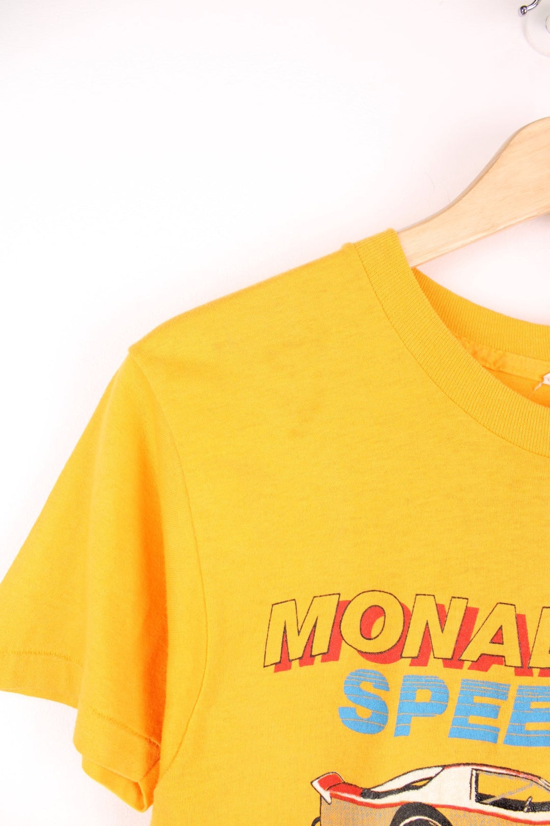 Vintage 80's Nascar Single Stitch T-Shirt in a yellow colourway, Monadnock Speedway race course, has the spell out and nascar printed on the front.