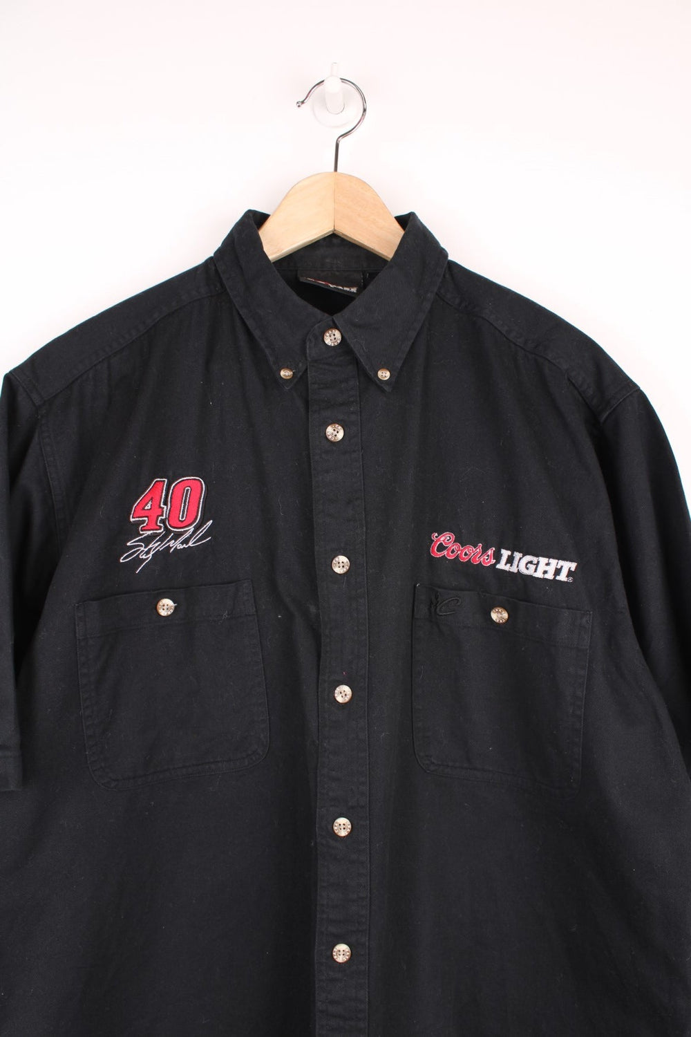 Chase Nascar Racewear, Coors Light Shirt in a black colourway, button up with double chest pockets, and has the brand logos above each pocket.