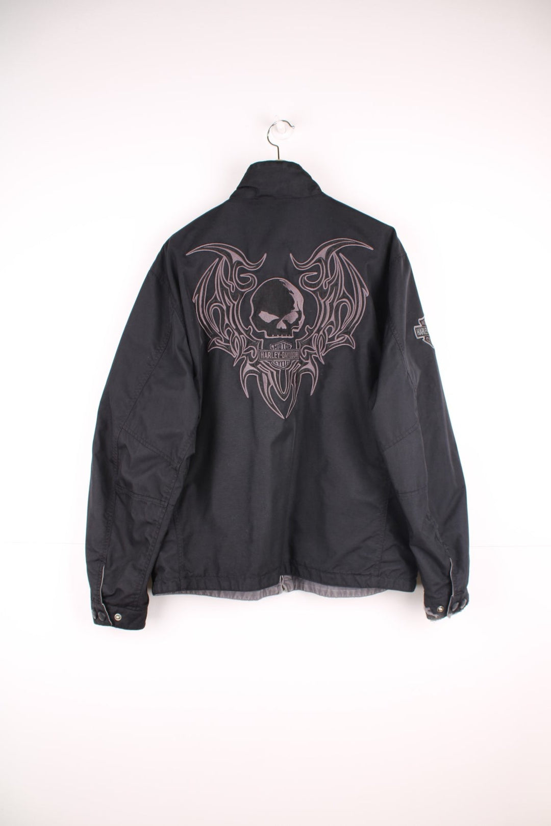 Harley Davidson reversible motorcycle jacket in black and grey colourway. Features embroidered spell-out details across the shoulders and on the front