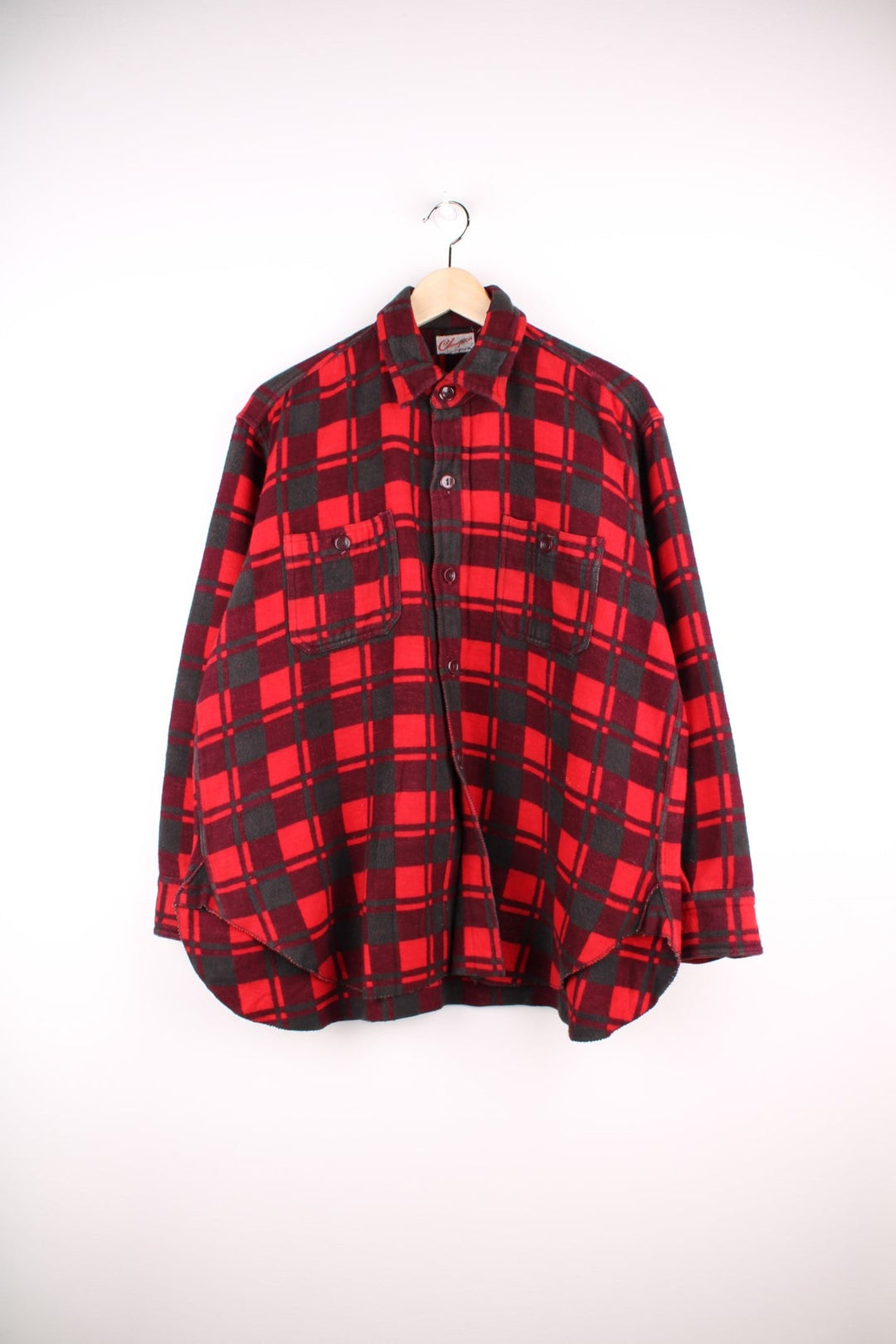 Champion shirt in Red plaid with two pockets and button closure.