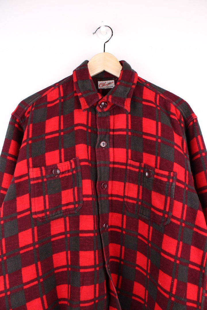 Champion shirt in Red plaid with two pockets and button closure.