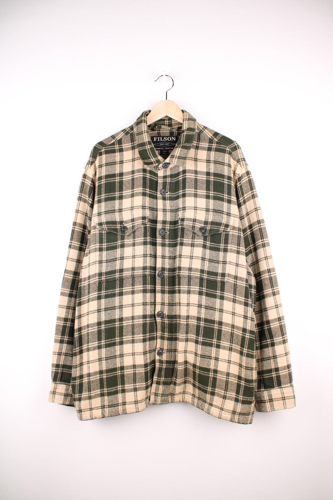 Filson Deer Island Jac shirt in Green and cream plaid with chest and side pockets and button closure.