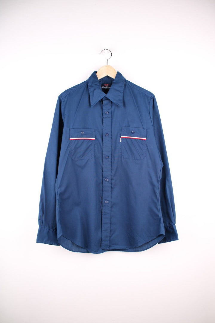 Levi's shirt in Blue with a dagger collar, red and white stripe detailing, two pockets and button closure.