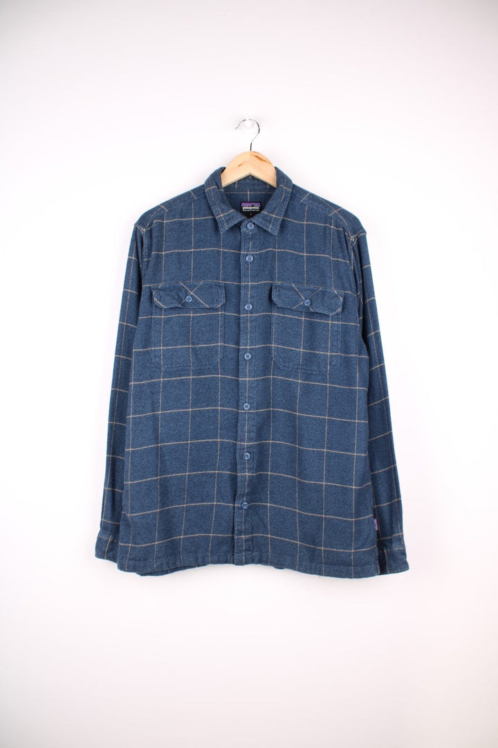 Patagonia organic cotton shirt in blue check with button closure and two chest pockets.