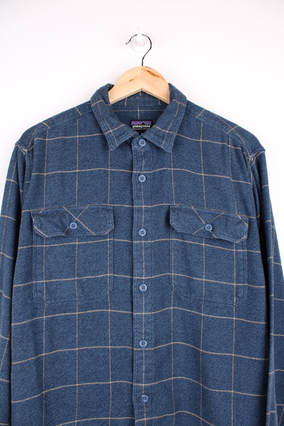 Patagonia organic cotton shirt in blue check with button closure and two chest pockets.